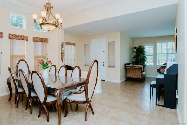 a view of a dining room with furniture and a chandelier
