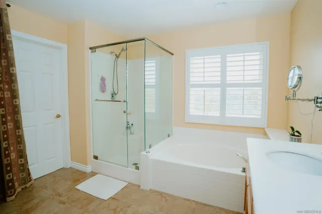 a bathroom with a bathtub and a shower