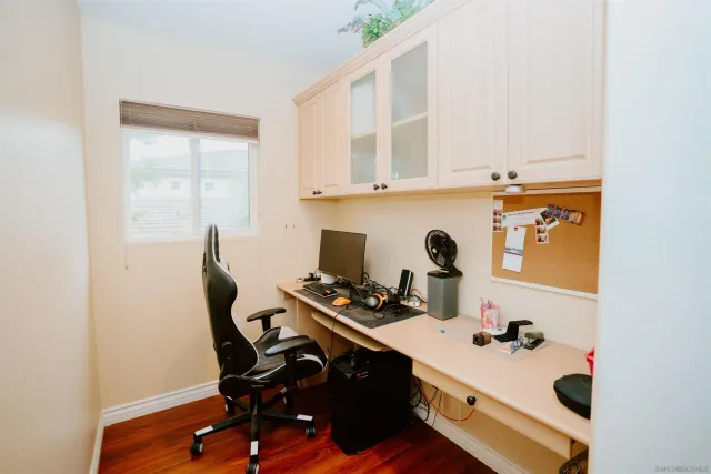 a view of a workspace with furniture and a window
