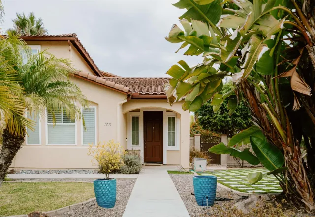 a front view of a house with a garden