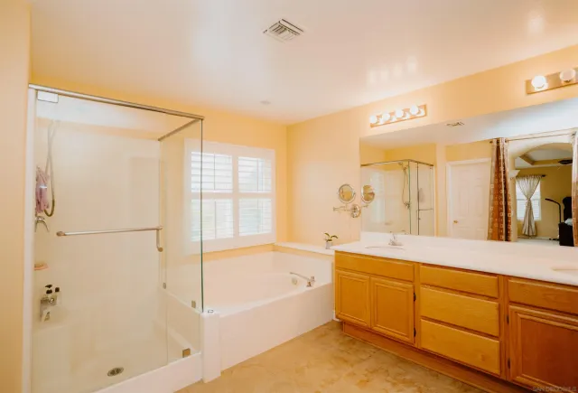 a spacious bathroom with a tub shower and sink