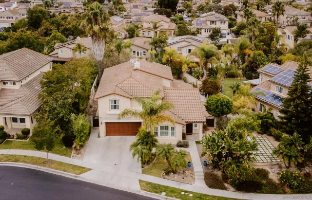 an aerial view of a house with a yard basket ball court and outdoor seating