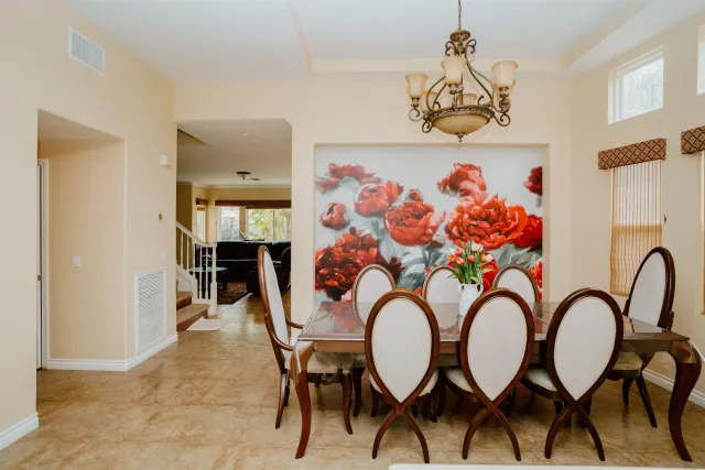 a view of a dining room with furniture and chandelier