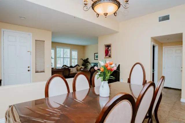 a view of a dining room with furniture and chandelier