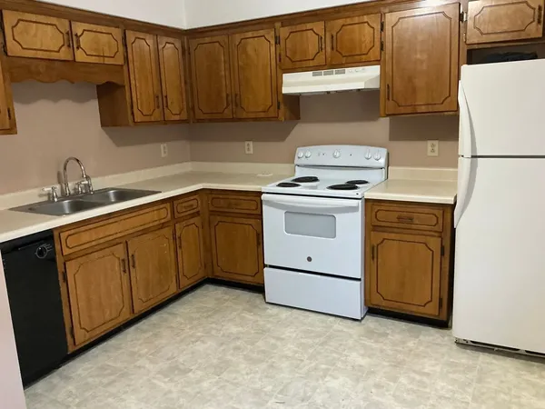 a kitchen with a sink stove and cabinets