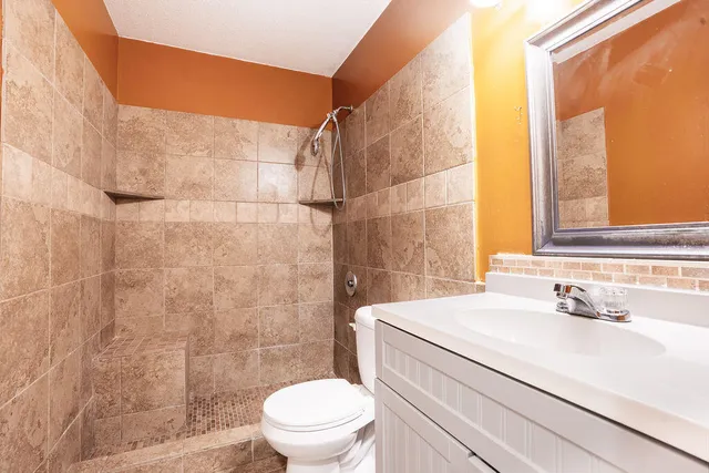 a bathroom with a sink toilet and shower