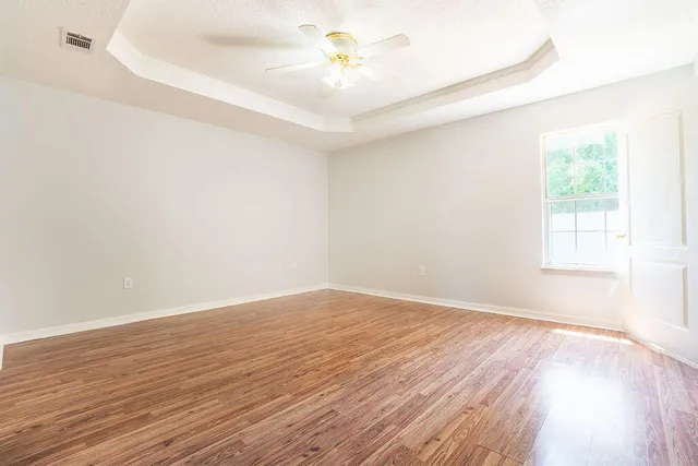 wooden floor in an empty room with a window