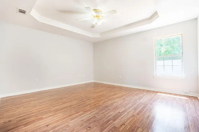wooden floor in an empty room with a window