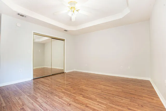 a view of an empty room with wooden floor