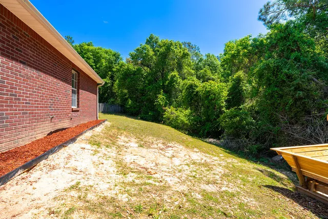a view of a backyard with wooden fence