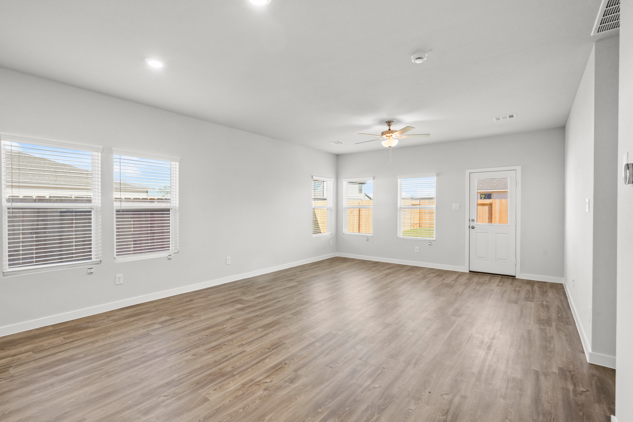 9720 Caney Bend Road Conroe, TX 77303 - Photo 8 of 24 a view of an empty room with wooden floor and a window