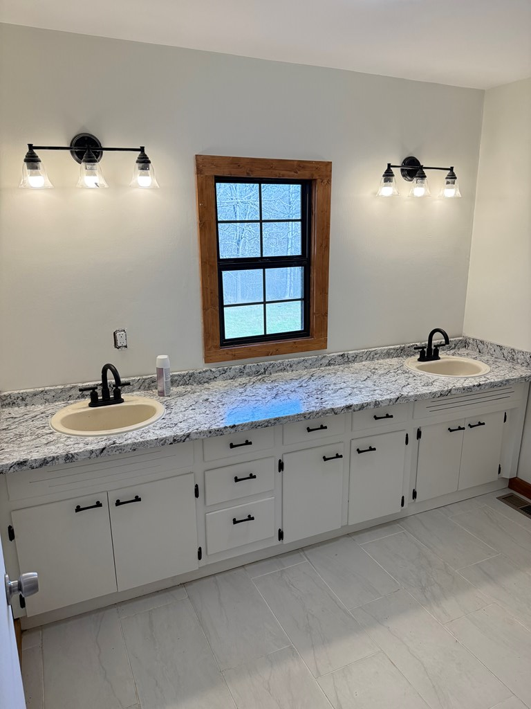 157 Old Loving Road Mineral Bluff, GA 30559 - Photo 6 of 10 a bathroom with a granite countertop sink and a window