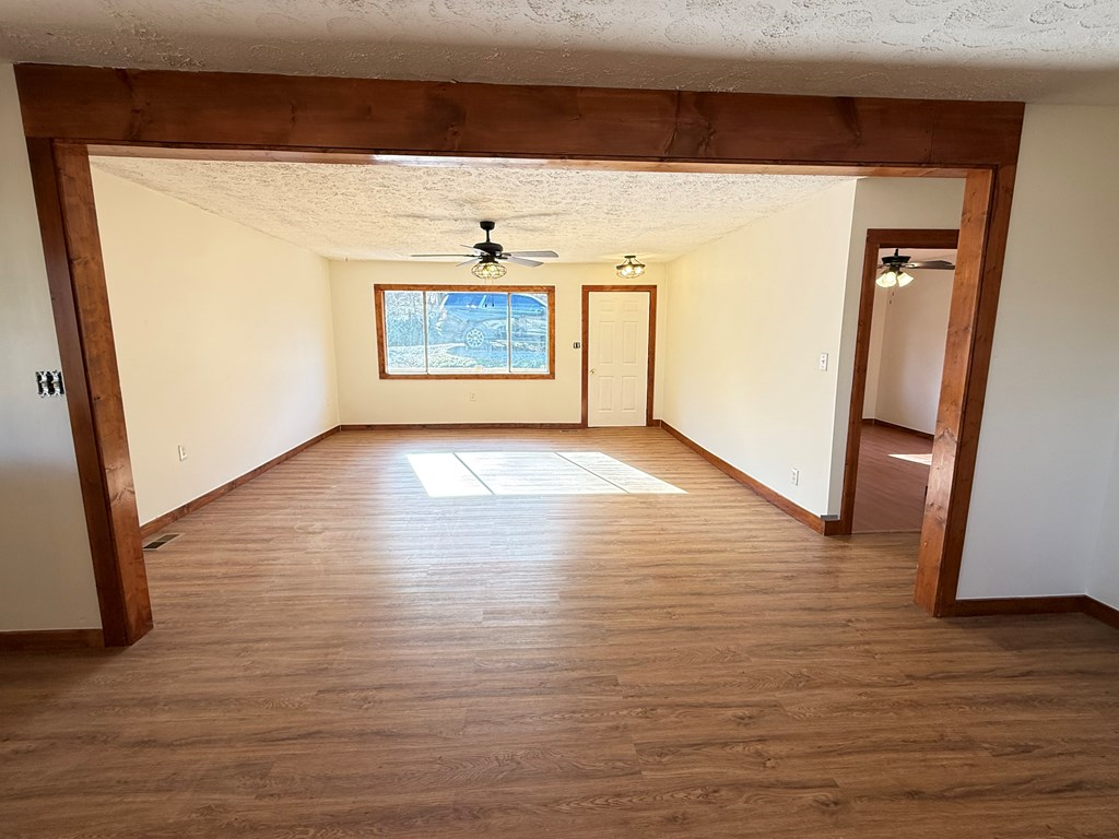157 Old Loving Road Mineral Bluff, GA 30559 - Photo 8 of 10 a view of an empty room with wooden floor and a window