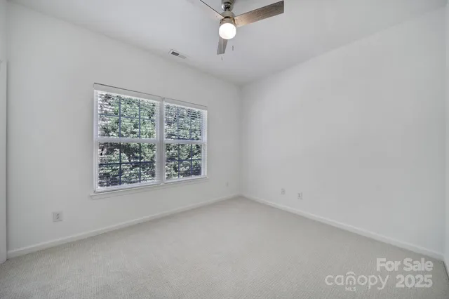an empty room with a empty space and a ceiling fan