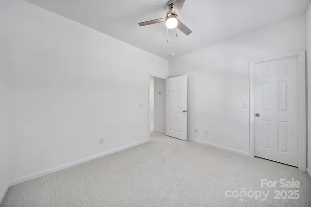 a bathroom with a granite countertop sink a toilet and a mirror