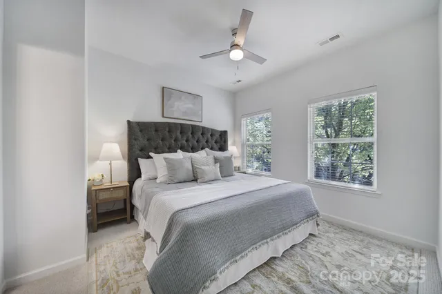 a bedroom with a bed and a lamp