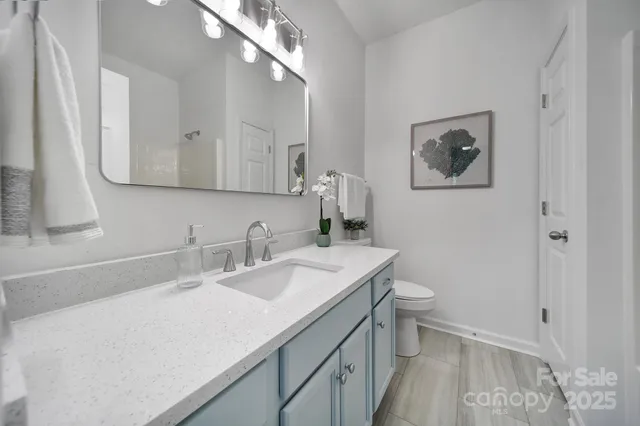 a bathroom with a tub shower and sink