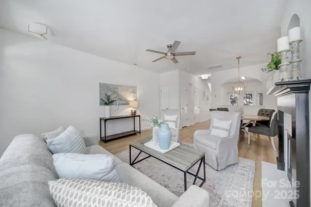 a living room with furniture and a chandelier