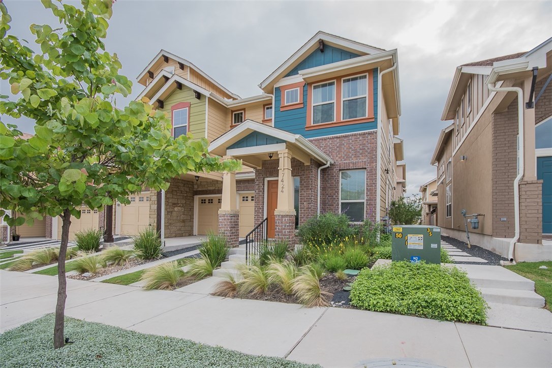7424 Easy Wind Drive Austin, TX 78757 - Photo 1 of 1 a front view of a house with a yard and potted plants