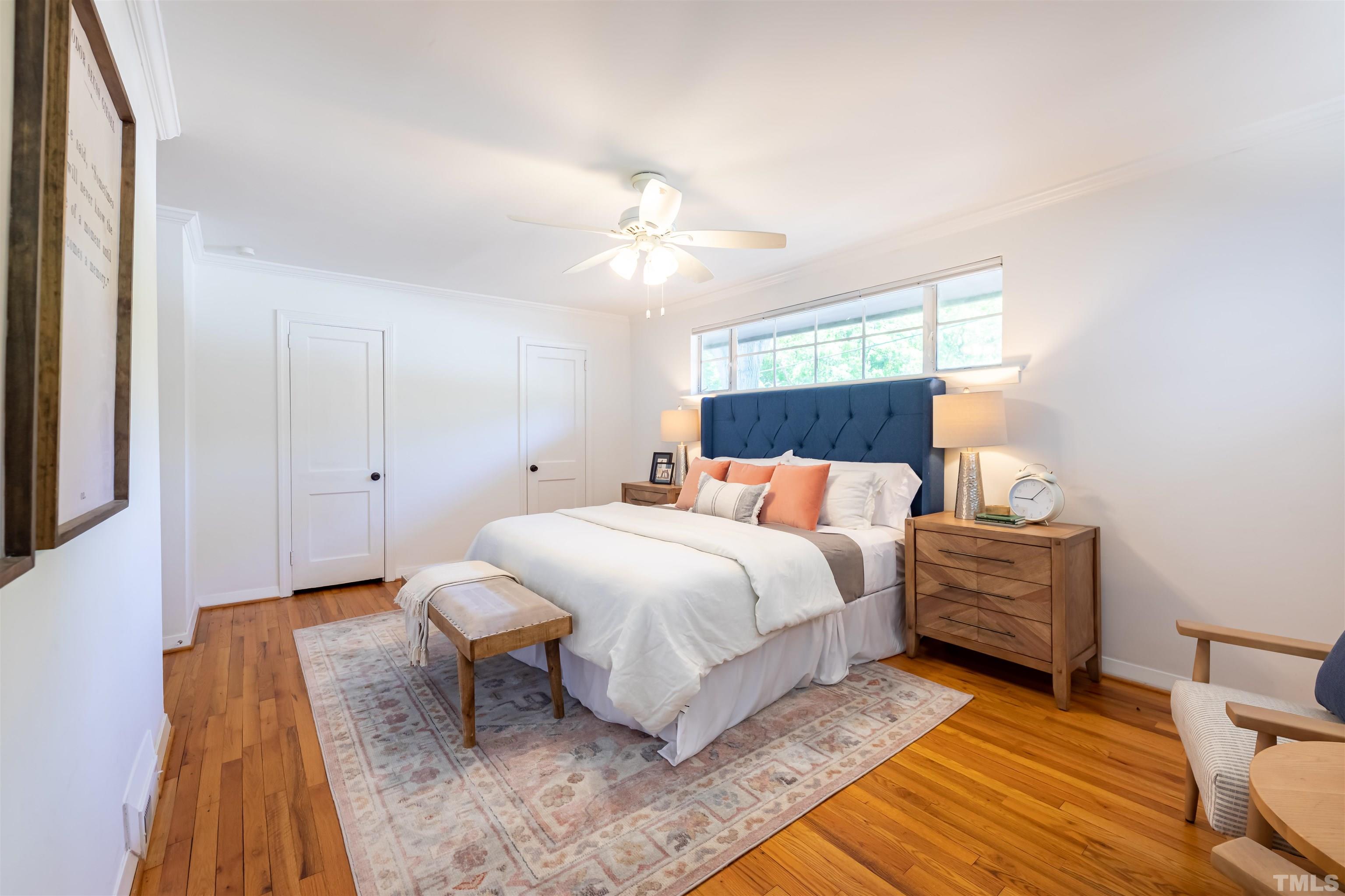1433 Chester Road Raleigh, NC 27608 - Photo 31 of 33 a bedroom with a bed and a chandelier