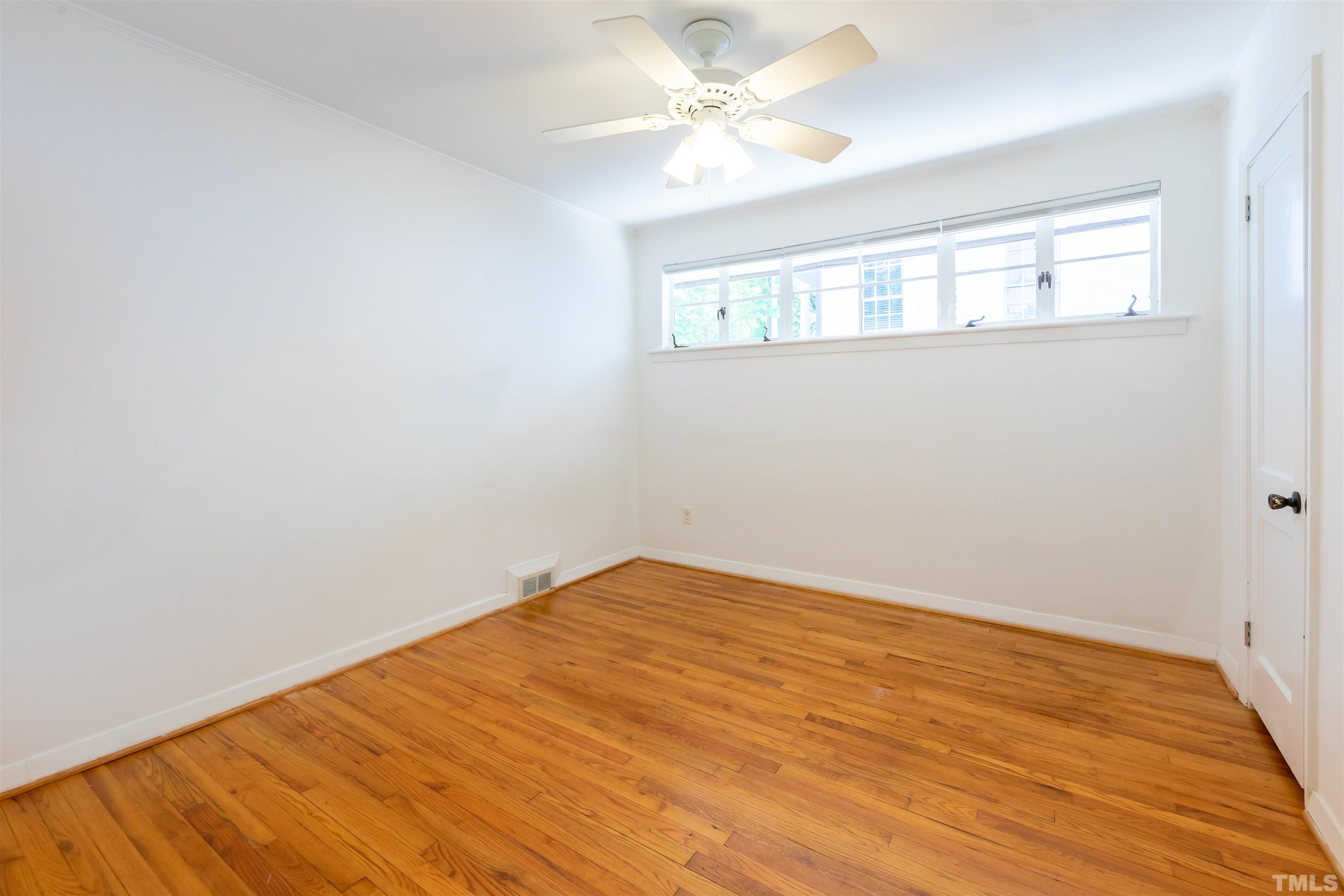 1433 Chester Road Raleigh, NC 27608 - Photo 33 of 33 wooden floor in an empty room with a window