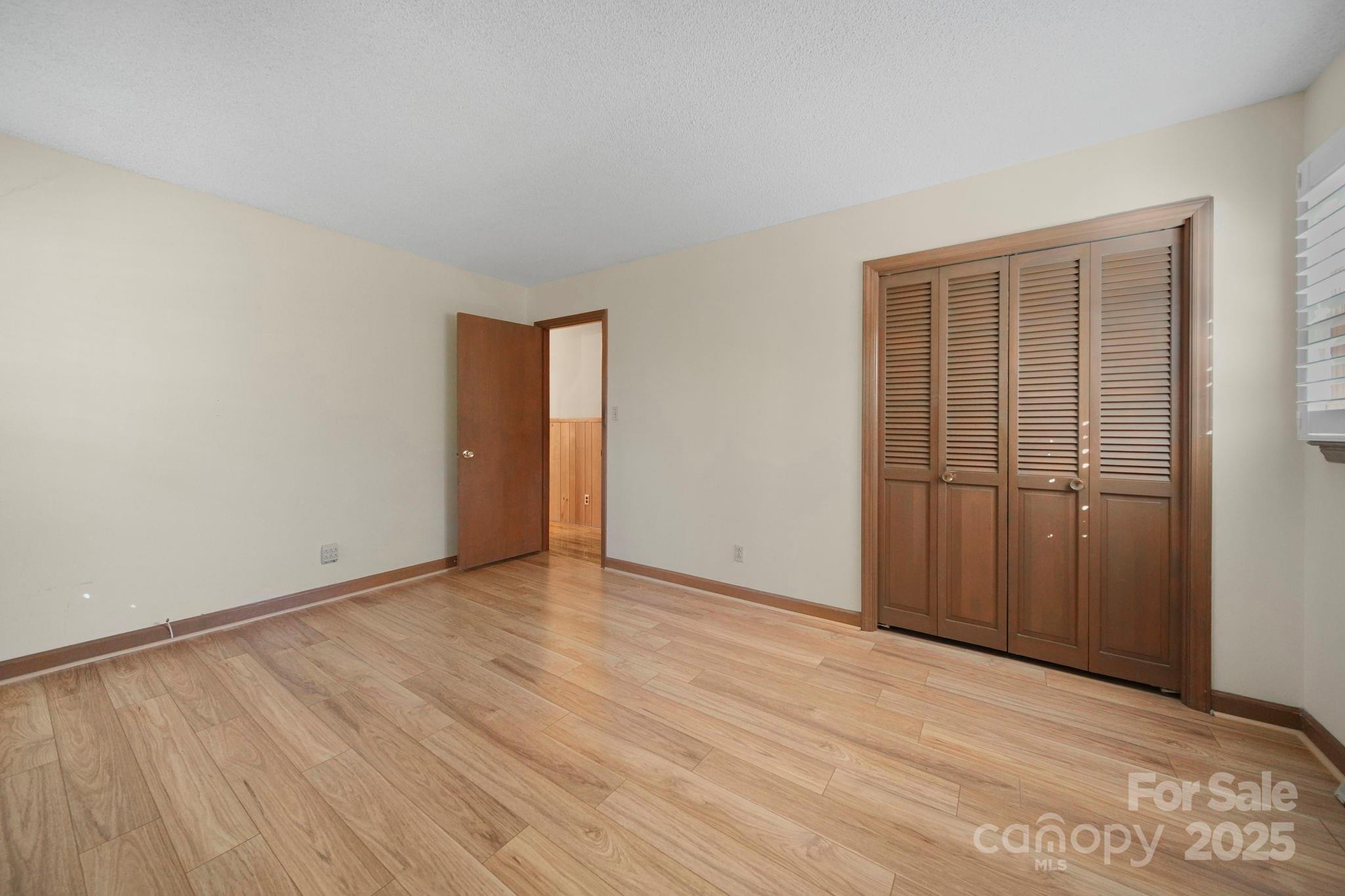 201 Smith Street, Unit 13 Wingate, NC 28174 - Photo 15 of 46 a view of an empty room with wooden floor