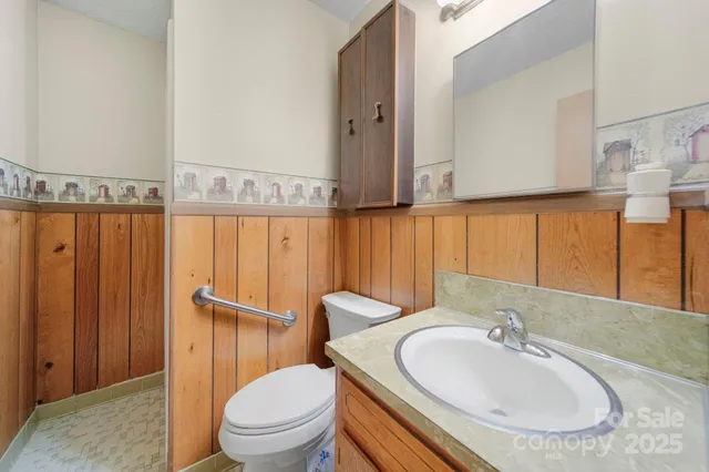 a bathroom with a sink a toilet and mirror