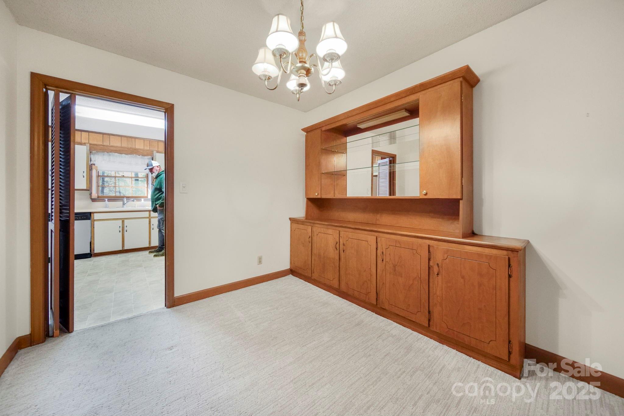201 Smith Street, Unit 13 Wingate, NC 28174 - Photo 26 of 46 a view of a hallway with a chandelier