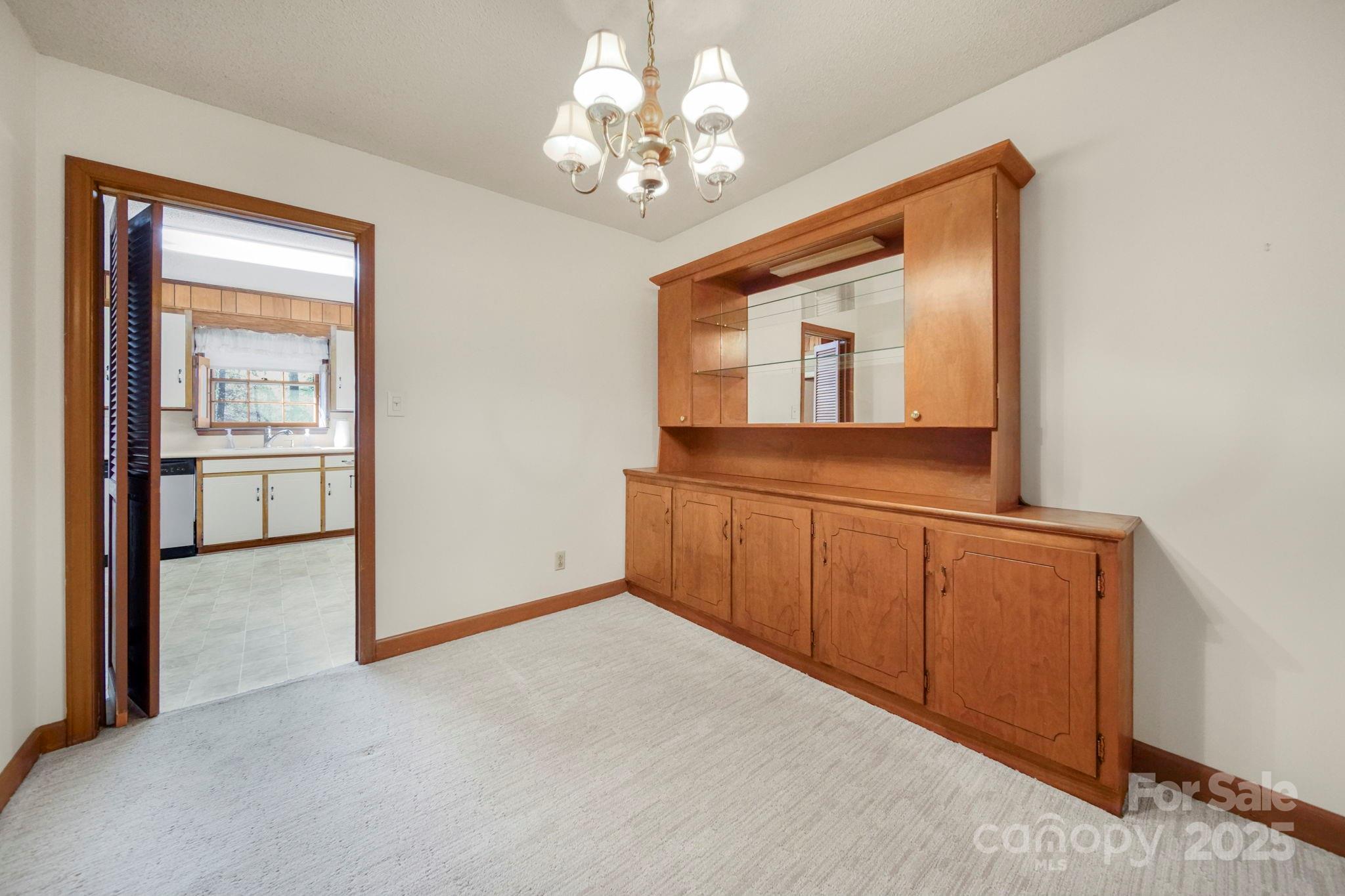 201 Smith Street, Unit 13 Wingate, NC 28174 - Photo 27 of 46 a view of a hallway with a chandelier