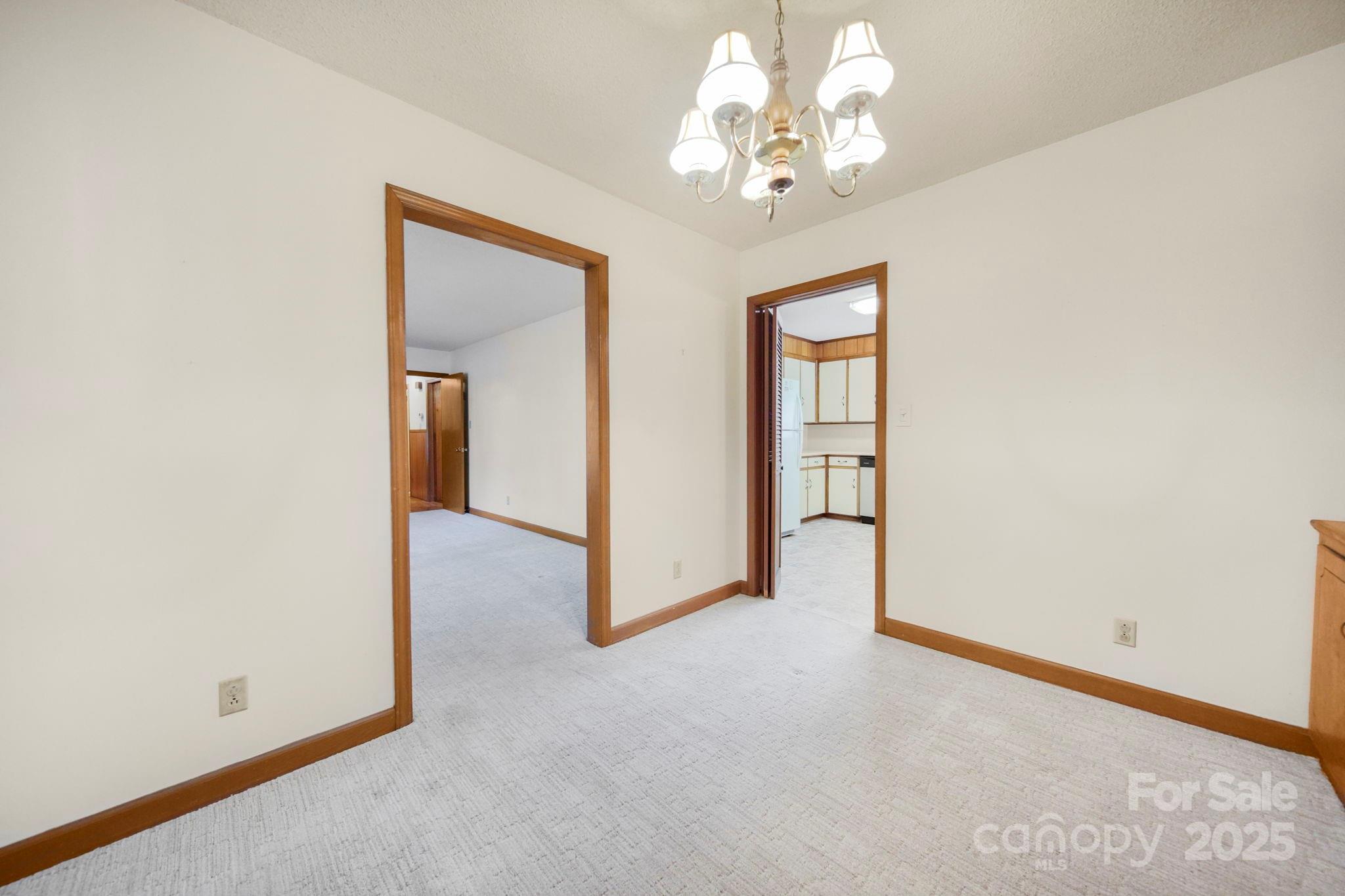 201 Smith Street, Unit 13 Wingate, NC 28174 - Photo 30 of 46 an empty room with chandelier fan