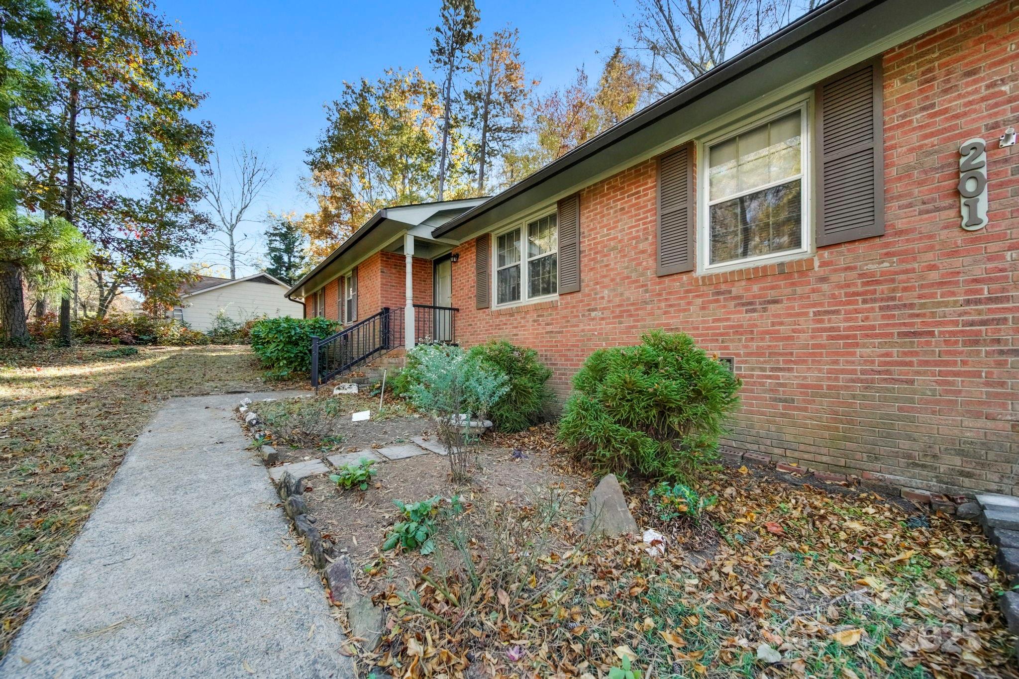 201 Smith Street, Unit 13 Wingate, NC 28174 - Photo 3 of 46 a front view of a house with garden
