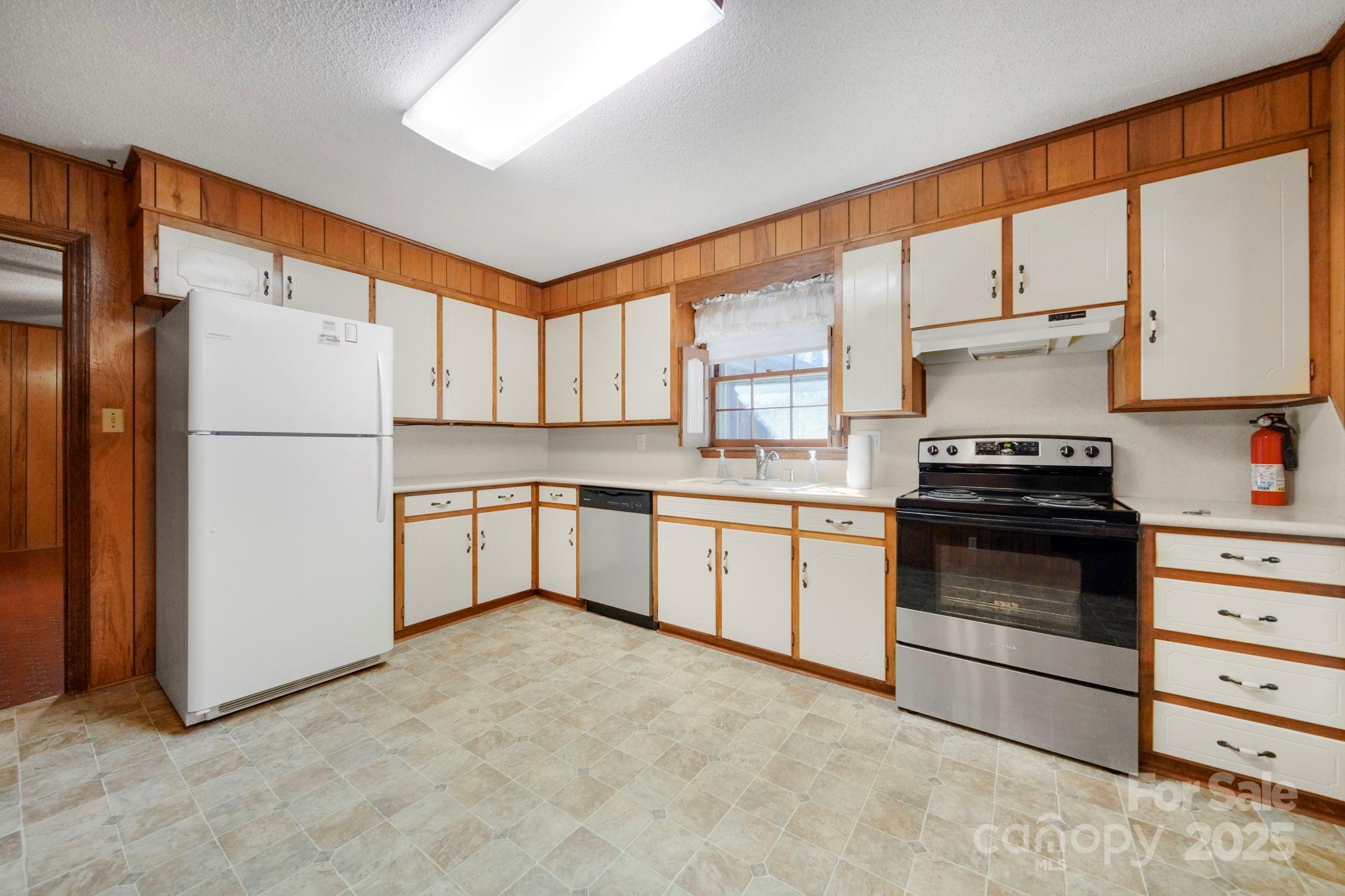 201 Smith Street, Unit 13 Wingate, NC 28174 - Photo 33 of 46 a kitchen with granite countertop white cabinets and white appliances