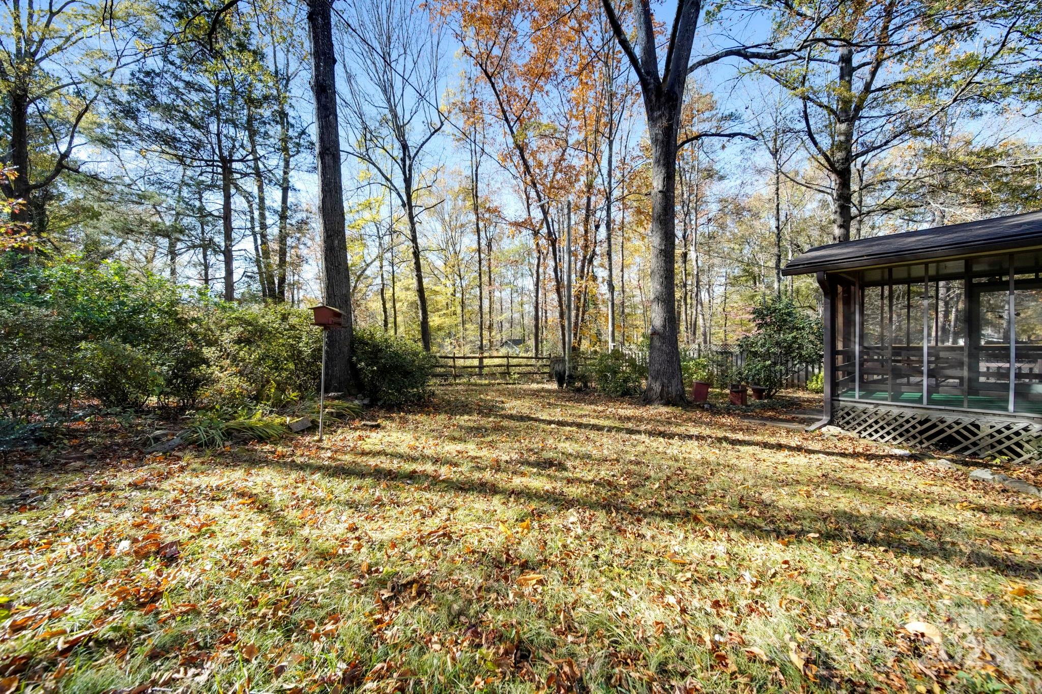 201 Smith Street, Unit 13 Wingate, NC 28174 - Photo 41 of 46 a backyard of a house with large trees and outdoor seating