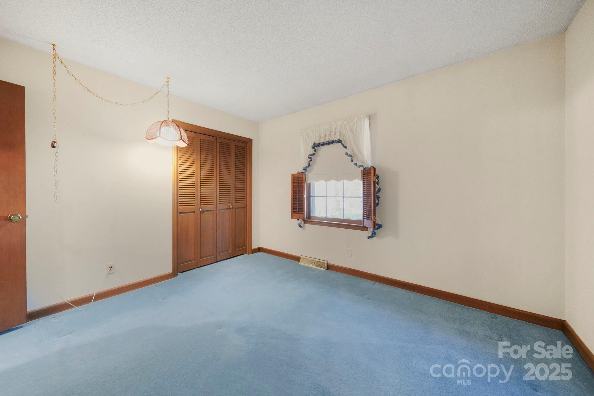 201 Smith Street, Unit 13 Wingate, NC 28174 - Photo 9 of 46 a view of empty room with front door