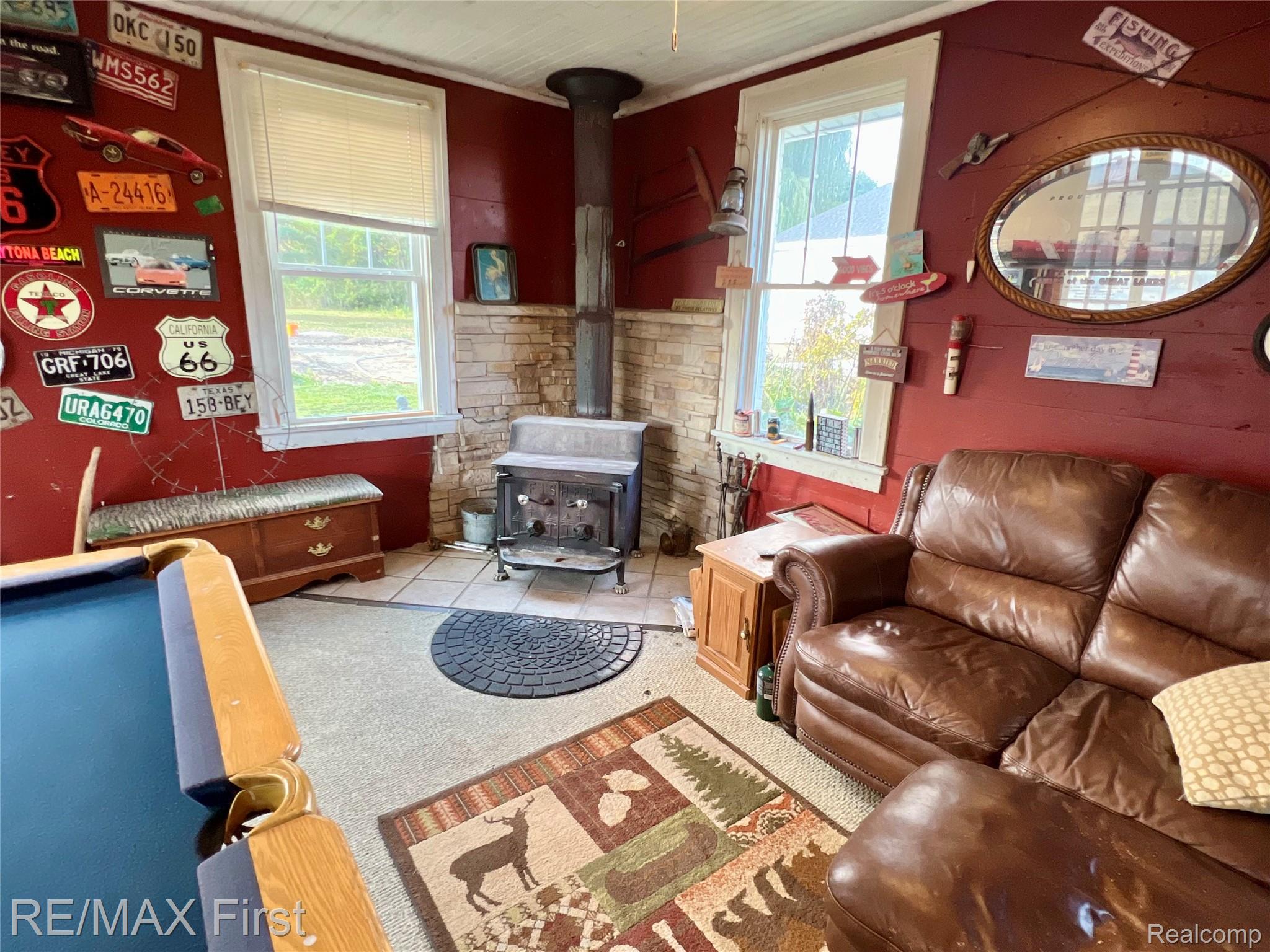 9280 River Road Algonac, MI 48001 - Photo 18 of 44 Living area with a wood stove and light tile patterned floors
