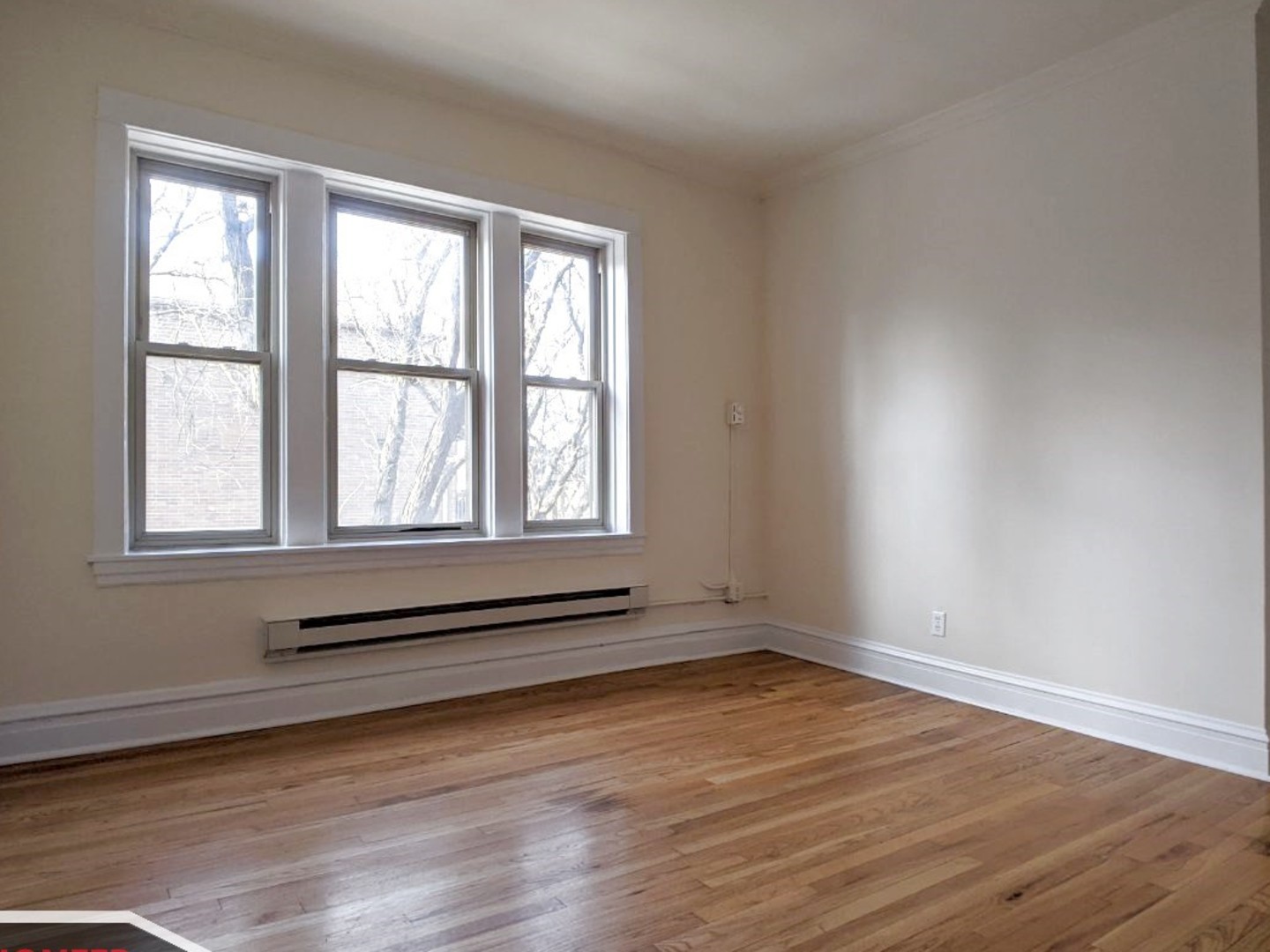2919 West George Street, Unit 2 Chicago, IL 60618 - Photo 2 of 14 wooden floor in an empty room with a window