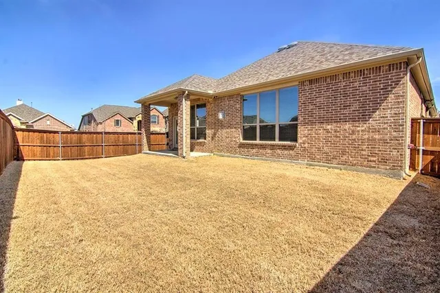 a view of a house with wooden fence