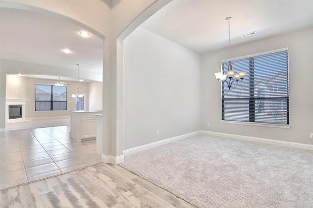 a view of an empty room with window and cabinet