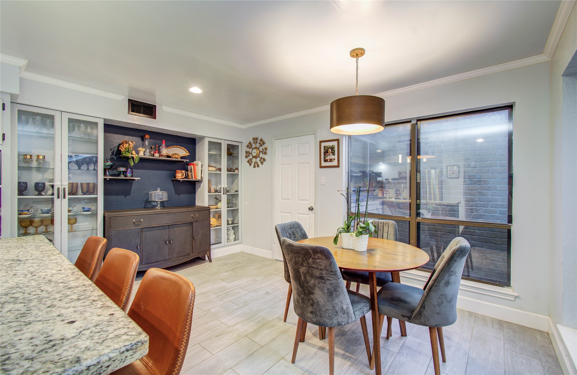 16707 Fernwood Way Houston, TX 77058 - Photo 17 of 46 a dining room with furniture a chandelier and wooden floor