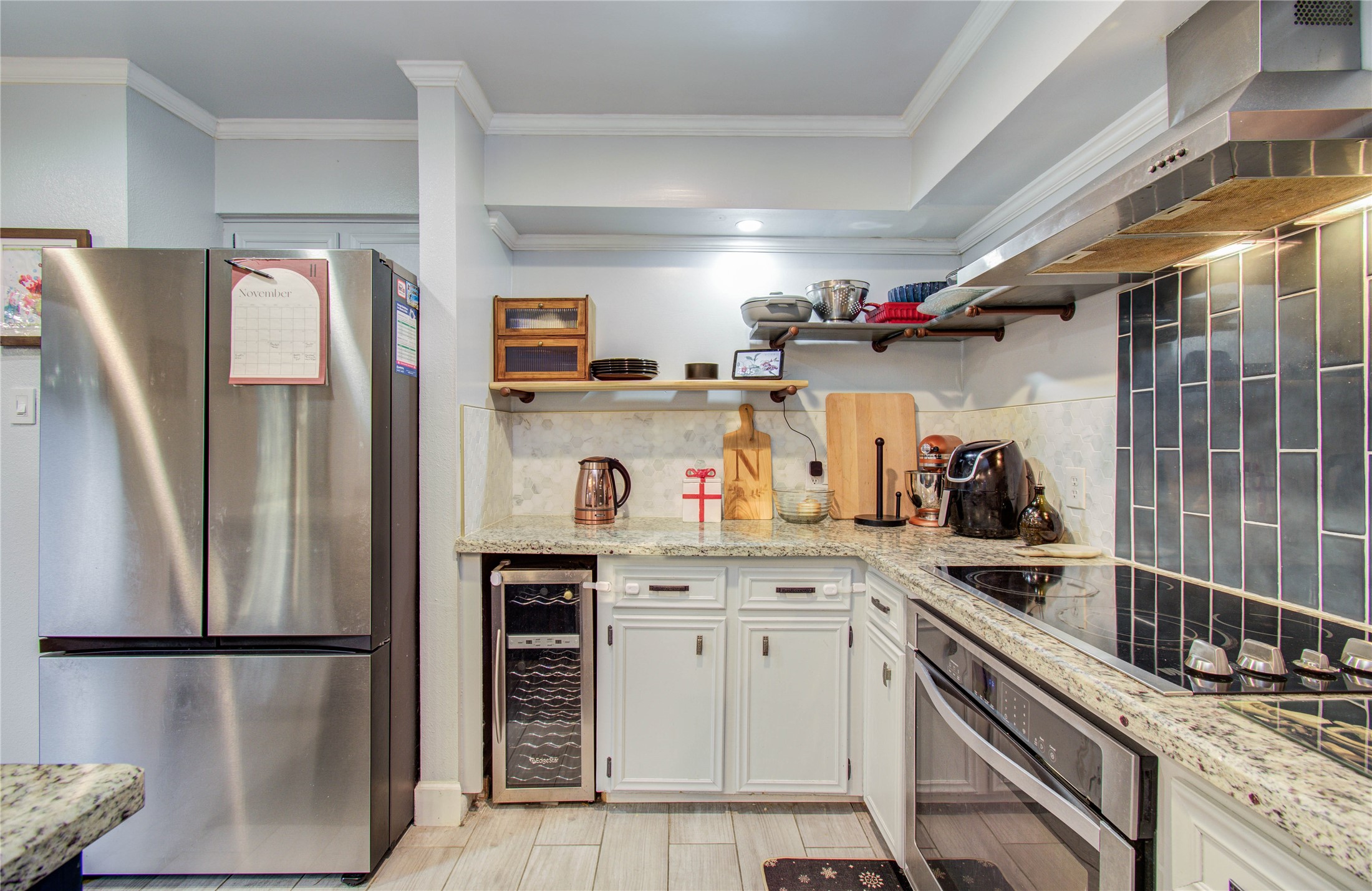 16707 Fernwood Way Houston, TX 77058 - Photo 18 of 46 a kitchen with a refrigerator and a sink