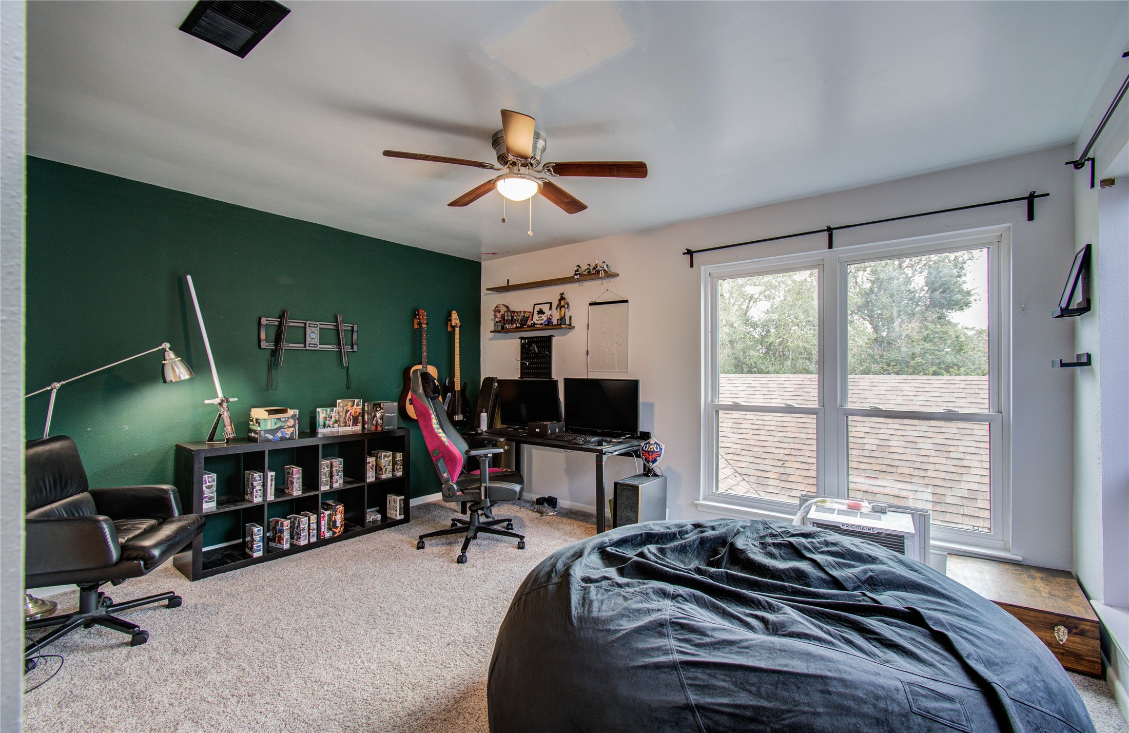 16707 Fernwood Way Houston, TX 77058 - Photo 30 of 46 a bed room with furniture and a flat screen tv