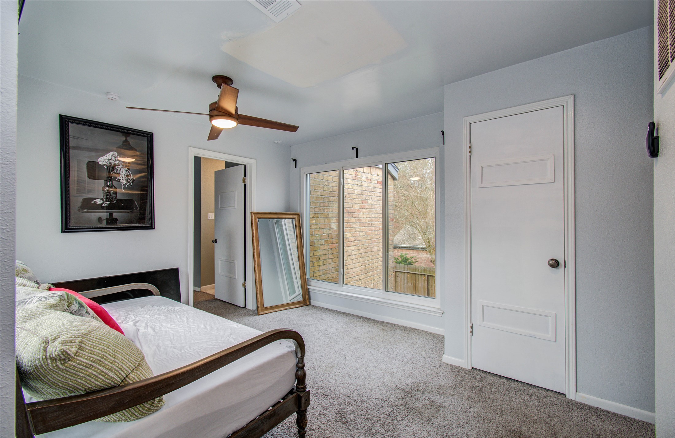 16707 Fernwood Way Houston, TX 77058 - Photo 32 of 46 a bedroom with a bed and a window