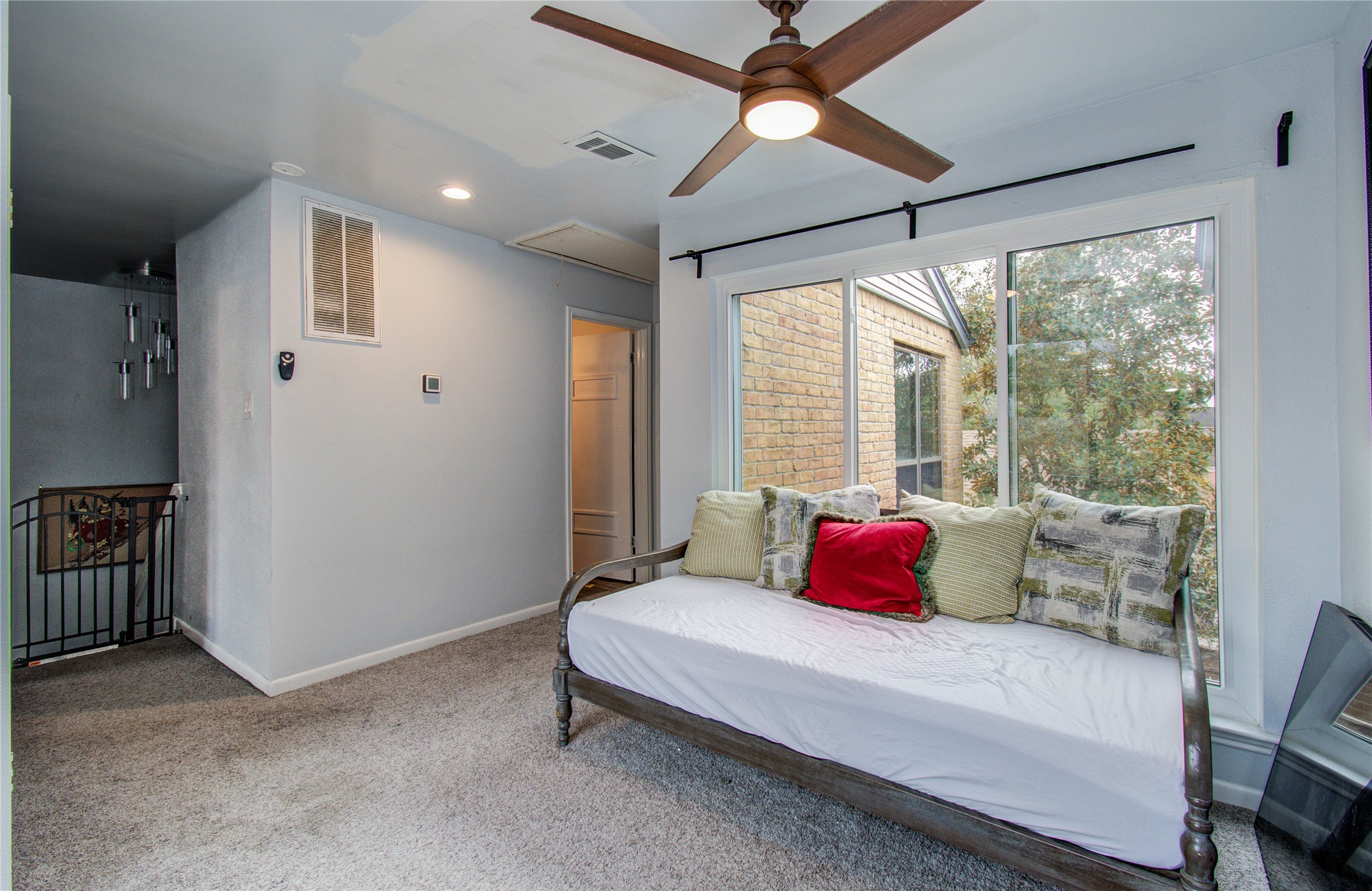 16707 Fernwood Way Houston, TX 77058 - Photo 33 of 46 a bedroom with a bed and a chandelier