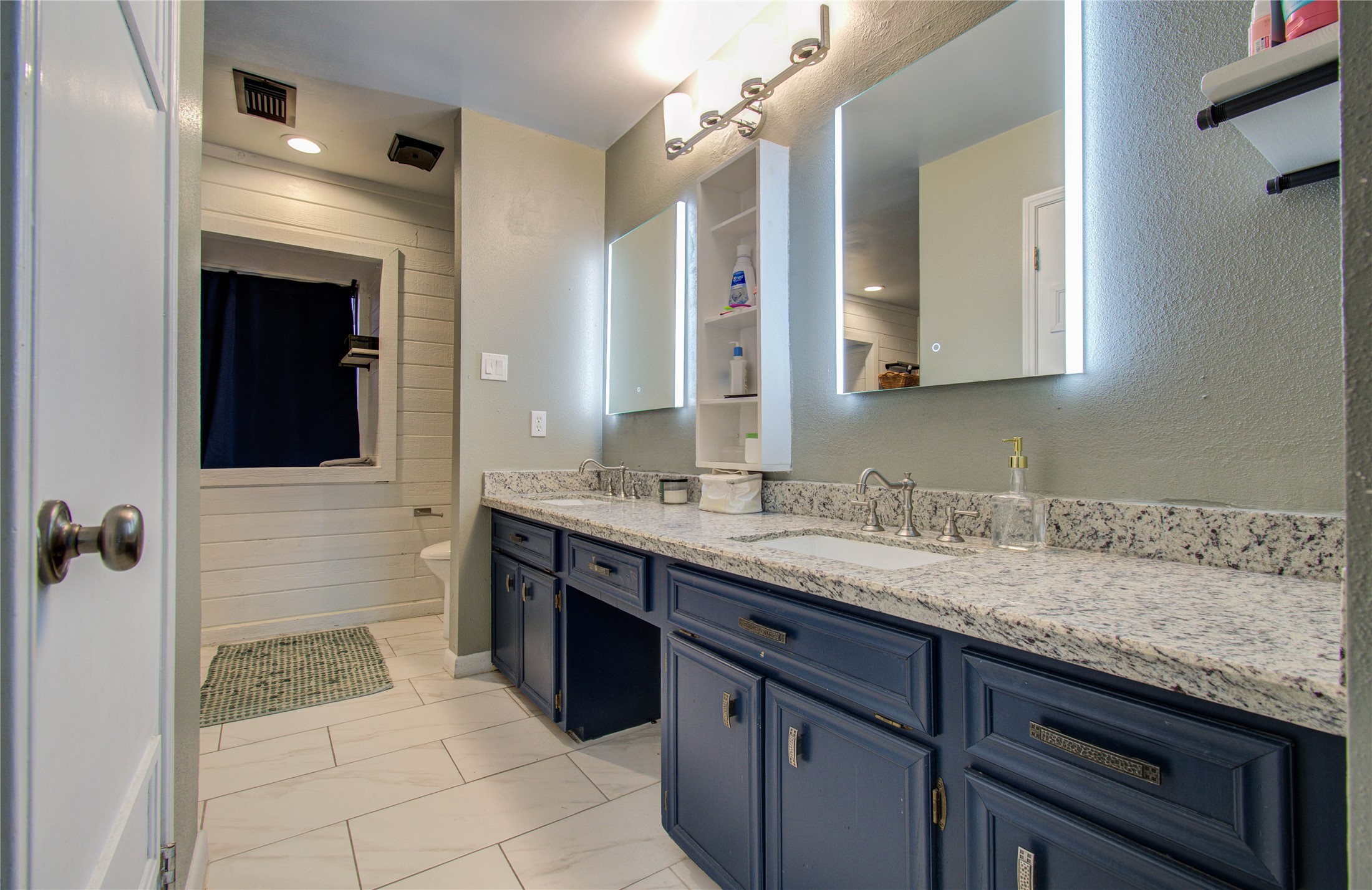 16707 Fernwood Way Houston, TX 77058 - Photo 37 of 46 a bathroom with a sink and a mirror