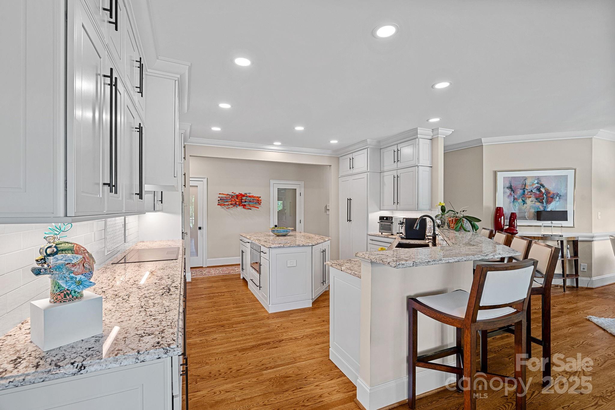 19501 River Falls Drive Davidson, NC 28036 - Photo 12 of 47 a large kitchen with cabinets table and chairs