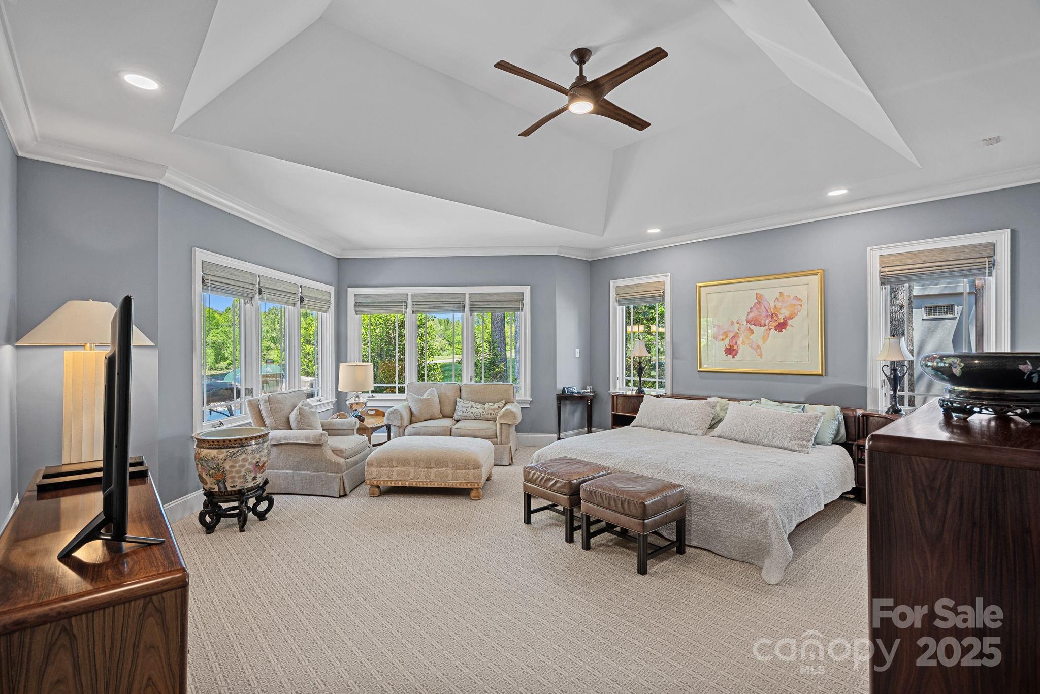 19501 River Falls Drive Davidson, NC 28036 - Photo 17 of 47 a bedroom with a bed gym equipment and a large window