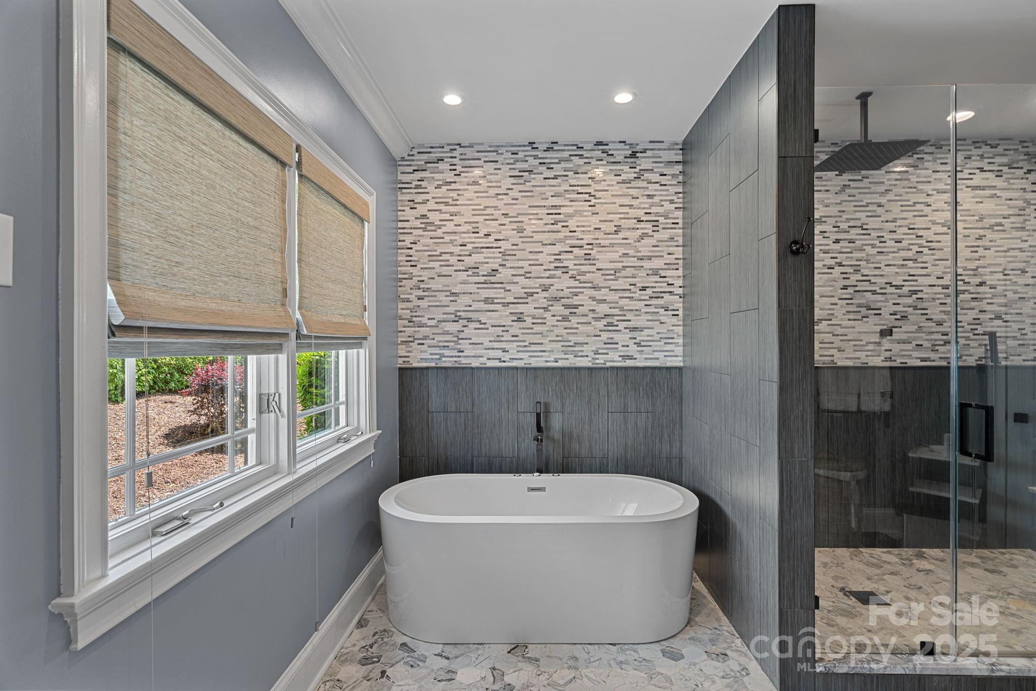 19501 River Falls Drive Davidson, NC 28036 - Photo 20 of 47 a bathroom with a bathtub and a shower