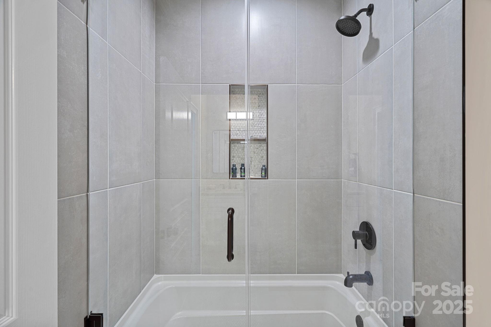 19501 River Falls Drive Davidson, NC 28036 - Photo 25 of 47 a bathroom with a bathtub and shower