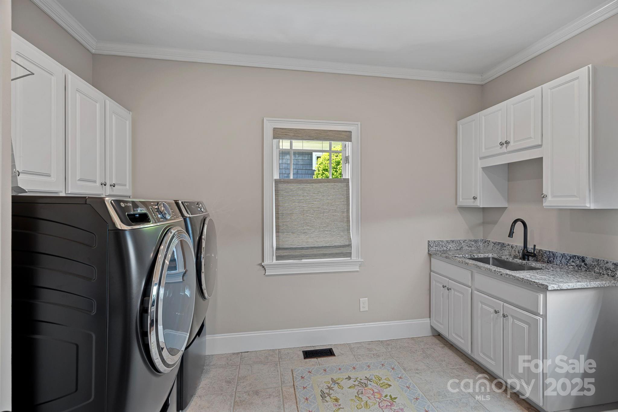 19501 River Falls Drive Davidson, NC 28036 - Photo 34 of 47 a utility room with cabinets washer and dryer