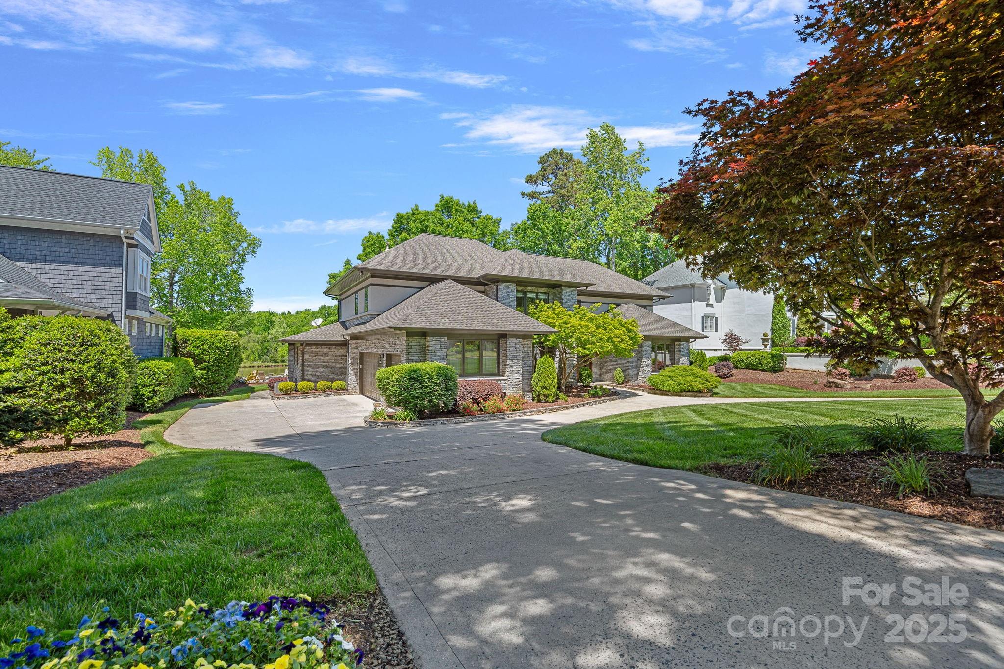 19501 River Falls Drive Davidson, NC 28036 - Photo 35 of 47 a front view of a house with a yard and potted plants
